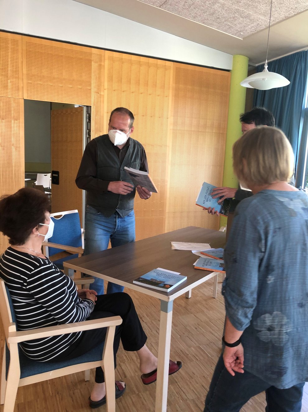 Personen halten Bücher.