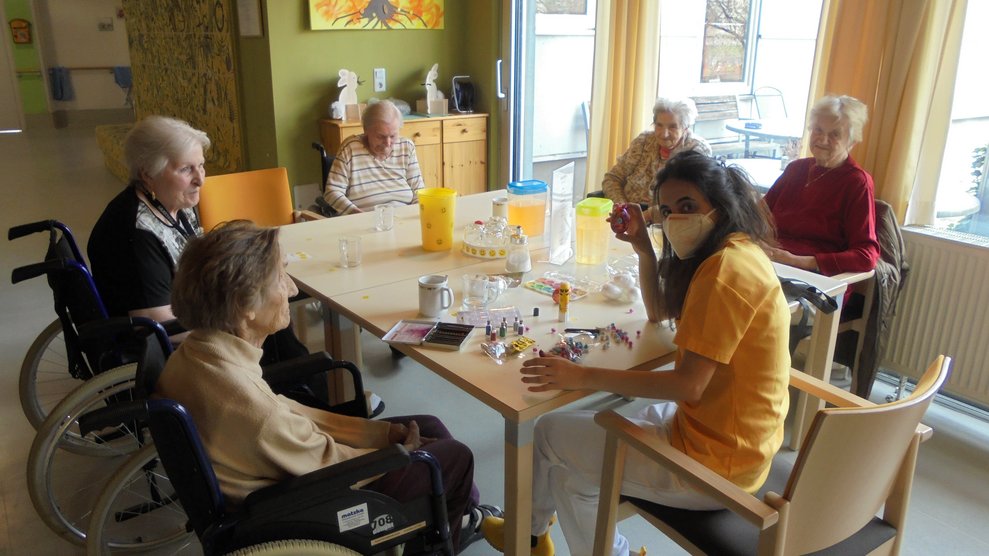 Die BewohnerInnen und eine Betreuerin dekorieren Ostereier.